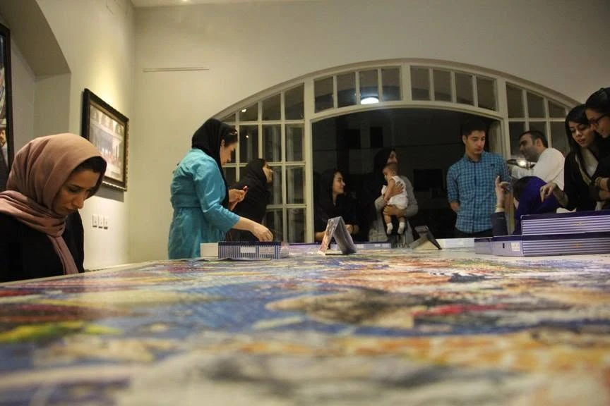 The 24,000-piece puzzle extending across the gallery table